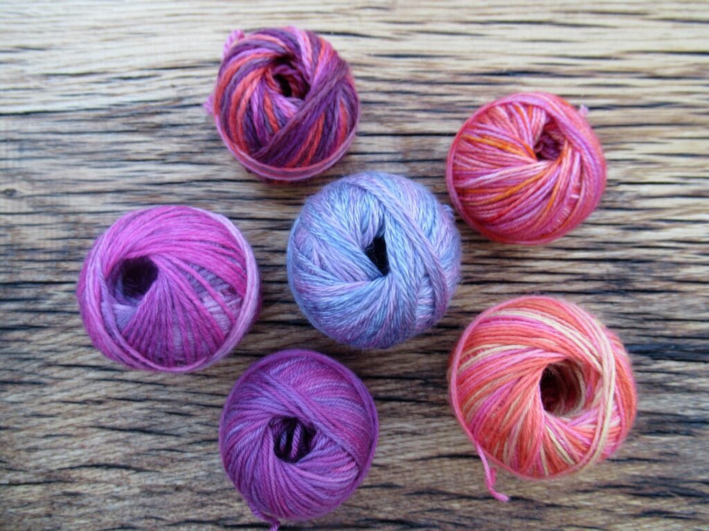 Heaven Descending Sock Yarn, Red and Pink Speckled Yarn